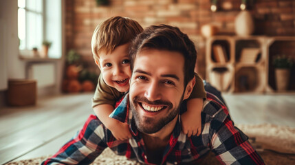 Happy loving daddy and cute boy playing active games at home. Family leisure concept