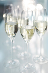 Champagne glasses on white background in bright lights