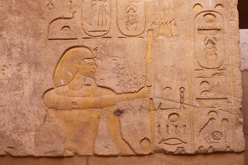 Ancient egyptian hieroglyphics carved on walls of Satet temple on Elephantine island in Aswan, Egypt