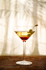 Glasses with martini and green olives