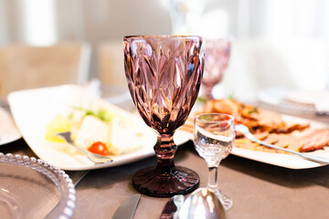 Luxurious Restaurant Table with shiny cutlery. Opulent Setting for Fine Dining Experience. High end restaurant. Romantic dinner. Sunlight table. Vodka shot glass.