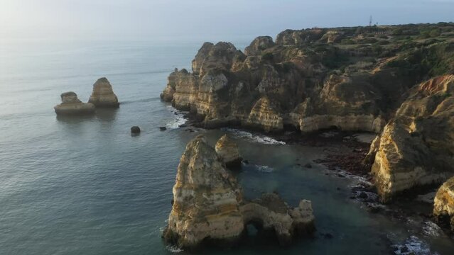 Aerial view of golden coast cliffs of portuguese southern beaches in Lagos City, Algarve, Portugal