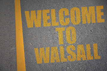 asphalt road with text welcome to Walsall near yellow line.