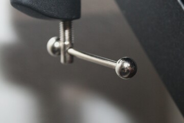 An iron tool is attached to the table