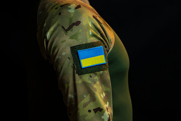  A soldier with the chevron of the national flag of Ukraine on his shoulder.