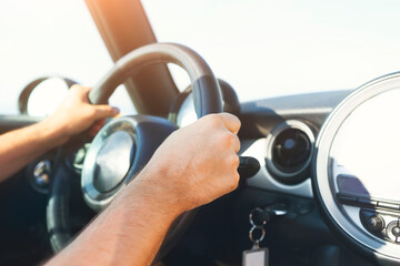 Cropped view of young man driving car