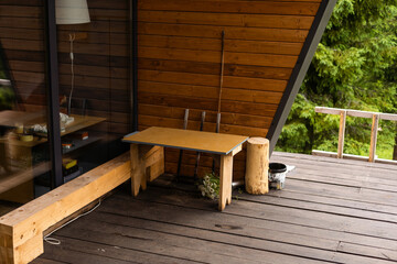Wooden terrace of wooden house. wooden planking. windows. Outside furniture. Perfect view on oak...