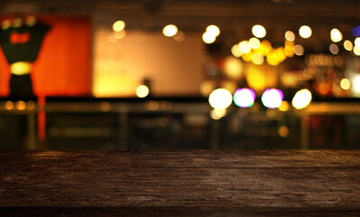 Empty wooden table in front of abstract blurred christmas tree background