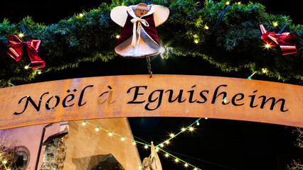Eguisheim, France - December 23, 2023: Traditional Christmas market in medieval town of Eguisheim in Alsace along the wine road - blue hour