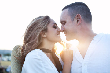 Cute young happy couple in love in a field of lavender flowers