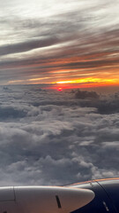 Fototapeta na wymiar View from Airplane Window in Flight at Sunset