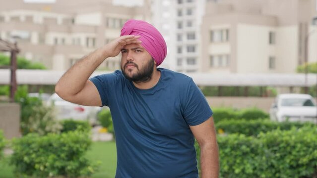 Sikh Indian Man Looking Around With Hand On Forehead