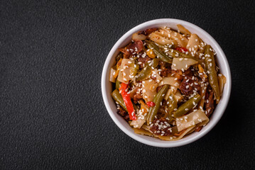 Delicious Asian dish udon with hot peppers, green beans, spices and herbs