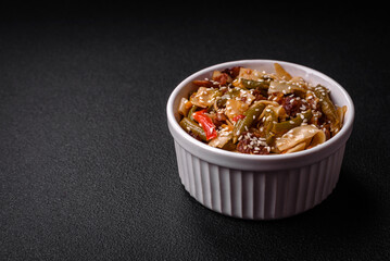 Delicious Asian dish udon with hot peppers, green beans, spices and herbs