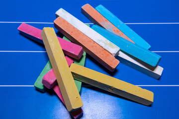 Children's multi-colored chalk for drawing and writing on a blue board