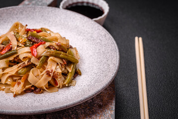 Delicious Asian dish udon with hot peppers, green beans, spices and herbs