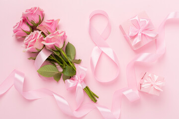 Composition with pink roses, gift box and eight made of ribbon on color background, top view. Women's day concept