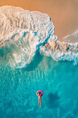 Girl with a circle on the sea, top view. Selective focus. - obrazy, fototapety, plakaty