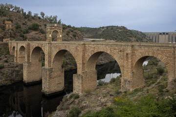 Fototapeta na wymiar In the center of the Roman bridge of Alcántara is Trajan's Triumphal Arch. An authentic work of engineering carried out by the Roman Empire on the Tagus River. Alcantara, Caceres, Spain