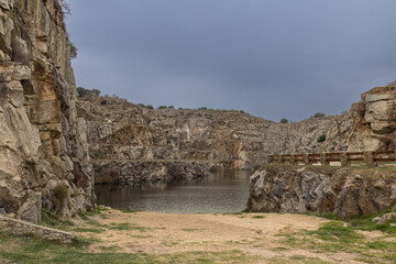 Natural pool in the old Alcántara quarry where stones and other materials were extracted for the construction of the Alcántara dam, Cáceres, Spain - obrazy, fototapety, plakaty