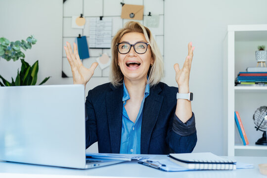 Shocked 50's mature businesswoman, middle-aged experienced female shouting after documents checking in office. Prepare Accounting report. Frustrated worried face expression emotion feelings problem
