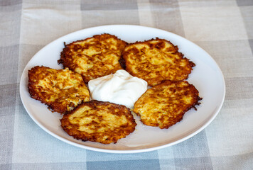 Potato pancakes on a plate with sour cream, Ukrainian national dish