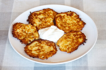 Potato pancakes on a plate with sour cream, Ukrainian national dish