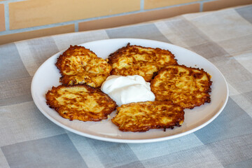 Potato pancakes on a plate with sour cream, Ukrainian national dish