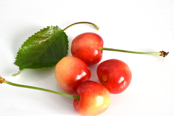 Yellow cherry fruits on a white background.