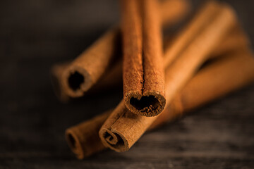 Cinnamon sticks on wooden background