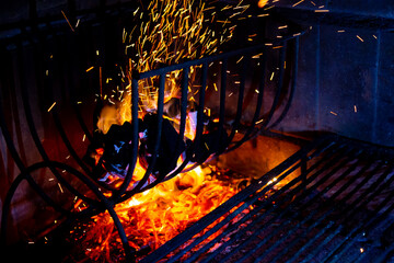 Lighting the fire for the barbecue. Burnt black charcoal igniting and preparing for the natural fire of the barbecue grill. Traditional Argentine barbecue.