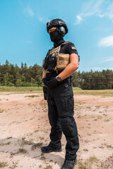 Special forces operatives in tactical gear practicing firearms training at an outdoor shooting range under a cloudy sky