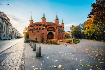 Fotobehang The Barbican in Krakow is the gate of the city's fortification near Market Square in Krakow, Rynek Głowny  in Krakow Poland. © alexanderuhrin