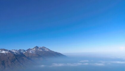 Mountain top above fog and clear sky.