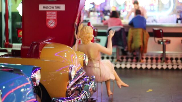 Retro cars headlights and bar with barman out of focus in restaurant