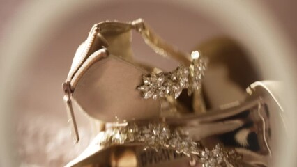 close-up of elegant high-heeled bridal shoes with sparkling embellishments.
The blurred perspective adds dreamy, romantic quality.
image captures the excitement and elegance of wedding preparations.