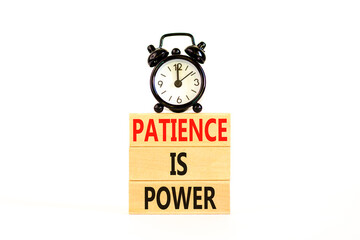 Patience is power symbol. Concept words Patience is power on beautiful wooden blocks. Beautiful white table white background. Black alarm clock. Business and patience is power concept. Copy space.