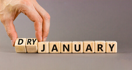 Dry January challenge symbol. Concept words Dry January on beautiful wooden cubes. Beautiful grey...