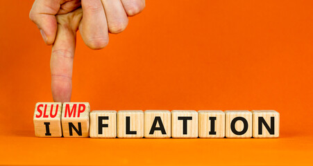 Inflation or slumpflation symbol. Concept word Inflation Slumpflation on beautiful wooden cubes. Beautiful orange background. Businessman hand. Business inflation slumpflation concept. Copy space.