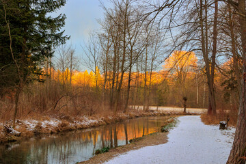 Path along the Brunnenbach stream through the Siebentischwald forest in Siebenbrunn at sunrise on a winter's day