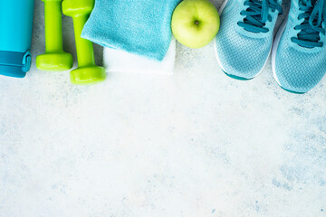 Fitness equipment, flat lay image. Sneakers, dumbbells, towel and green apple. Training, workout...