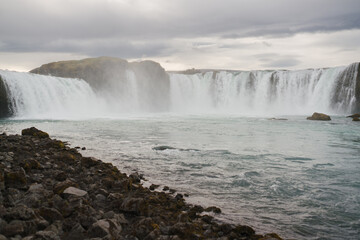Traveling and exploring Iceland landscapes and famous places. Autumn tourism by Atlantic Ocean and mountains. Outdoor views on beautiful cliffs and travel destinations. Godafoss waterfall.