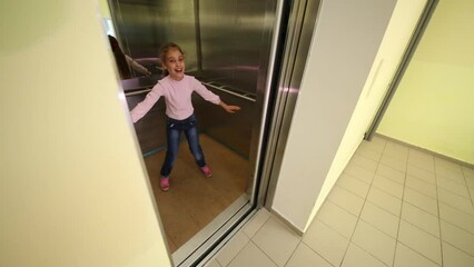 A girl comes into the elevator and arranges wide legs and arms