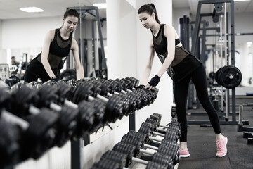 Two Women Working Out in a Gym, Strengthening Their Bodies and Achieving Fitness Goals