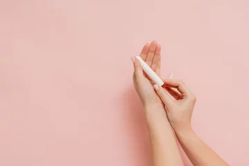 Deurstickers Medical feminine tampon in hand. Cotton swab. Menstruation © Anton Tolmachov