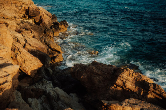 Waves one Cape Greco's Cliffs at Sunset