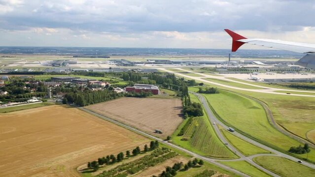 Landscape and airplane wing during aircraft comes in for landing.