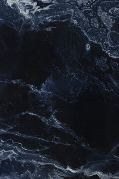 Marble blue background. Porcelain stoneware is dark blue. Ceramic tiles for finishing floor. Texture of stone slab. Graphic abstract background. Ceramic countertop.Vertical photo.