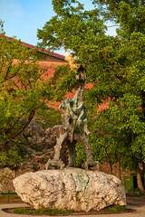 Fototapeta premium A green copper sculpture of a fire-breathing dragon in the ancient Wawel Castle in the center of the European city of Krakow.