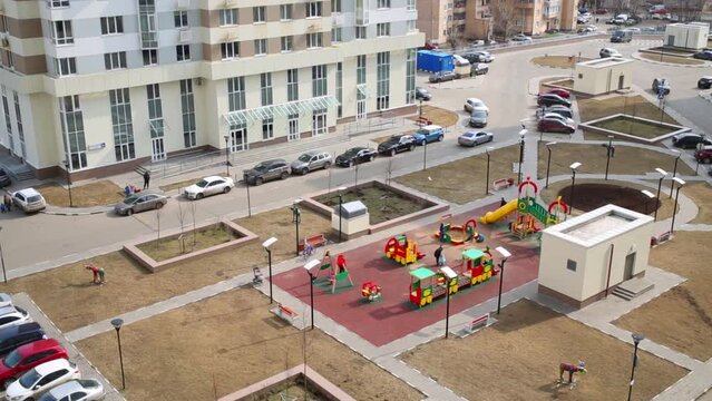 Children playground and car parking near residential buildings